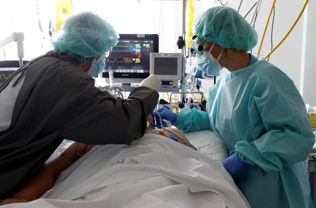 Varios sanitarios atienden a un paciente con Covid. - EFE