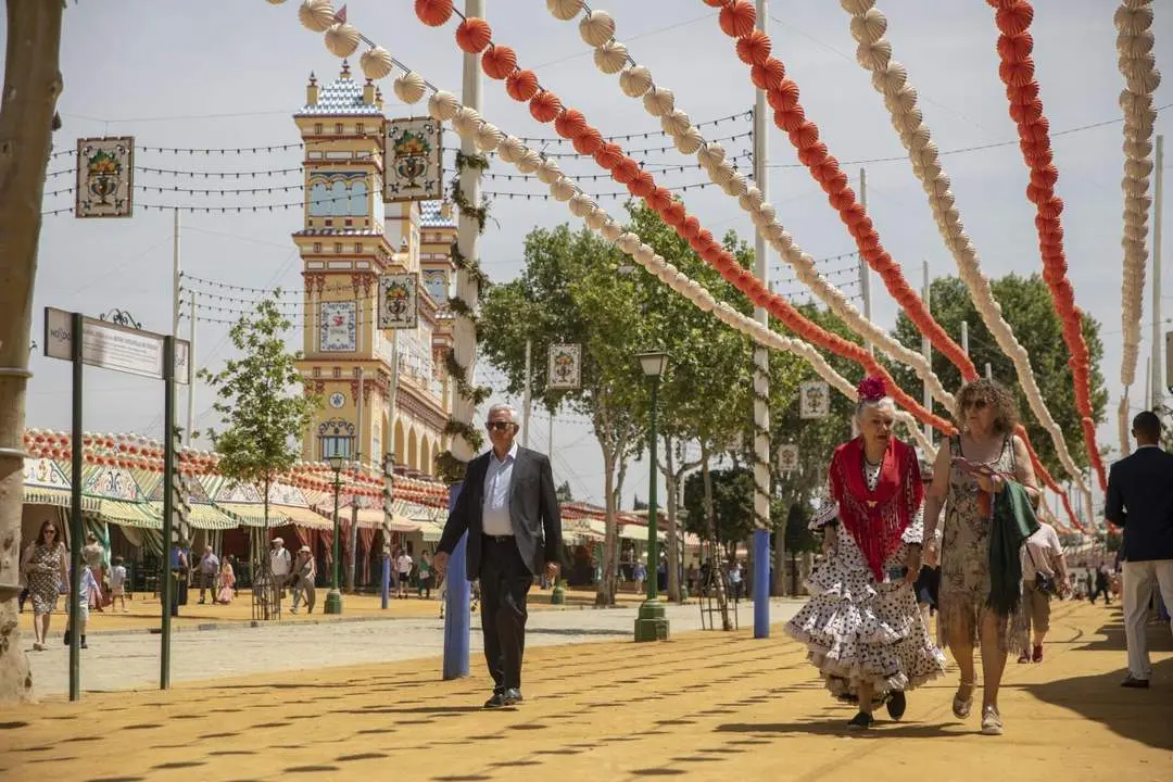 Paseantes por el Real de la Feria. - Archivo