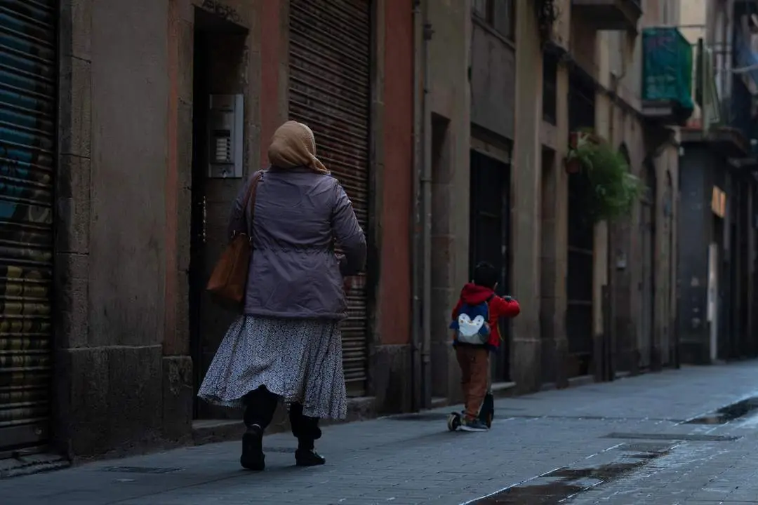 Una mujer de origen magreb&iacute; camina por una calle de Barcelona. - Europa Press