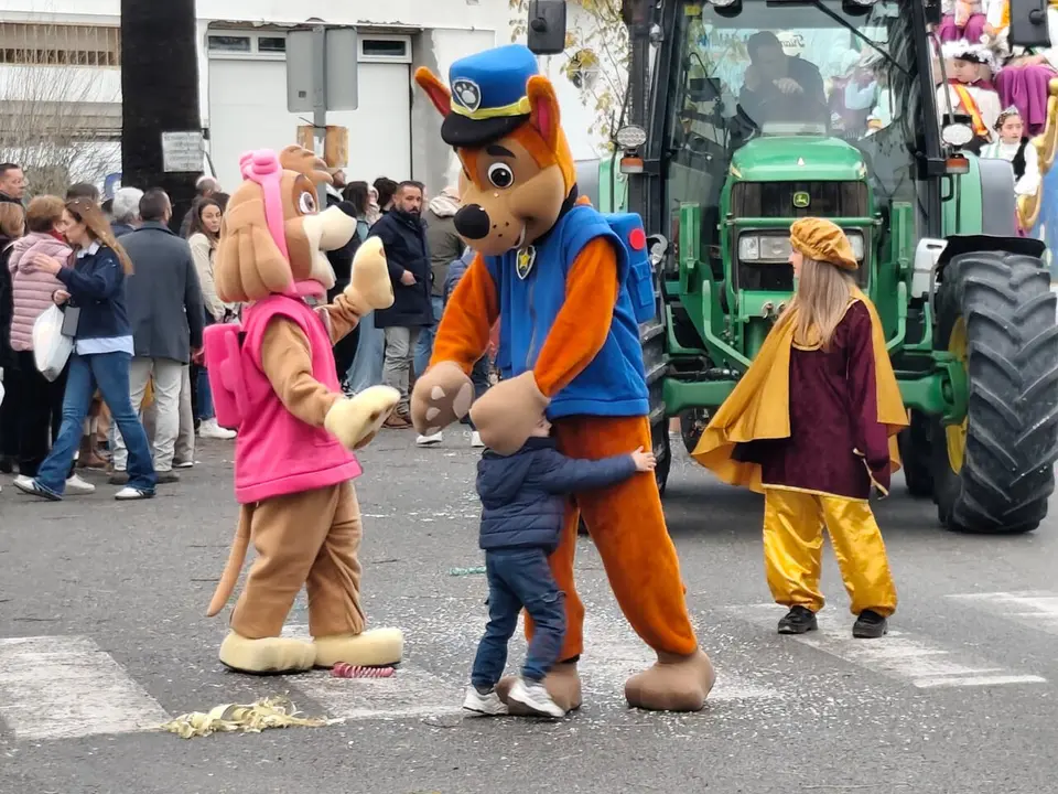 Un ni&ntilde;o abraza a uno de los personajes animados de la cabalgata arcense./ MAC&Iacute;AS