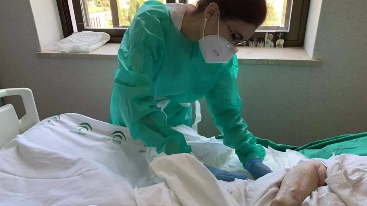 Una profesional sanitaria atiende a una persona ingresada en el hospital en M&aacute;laga - Junta