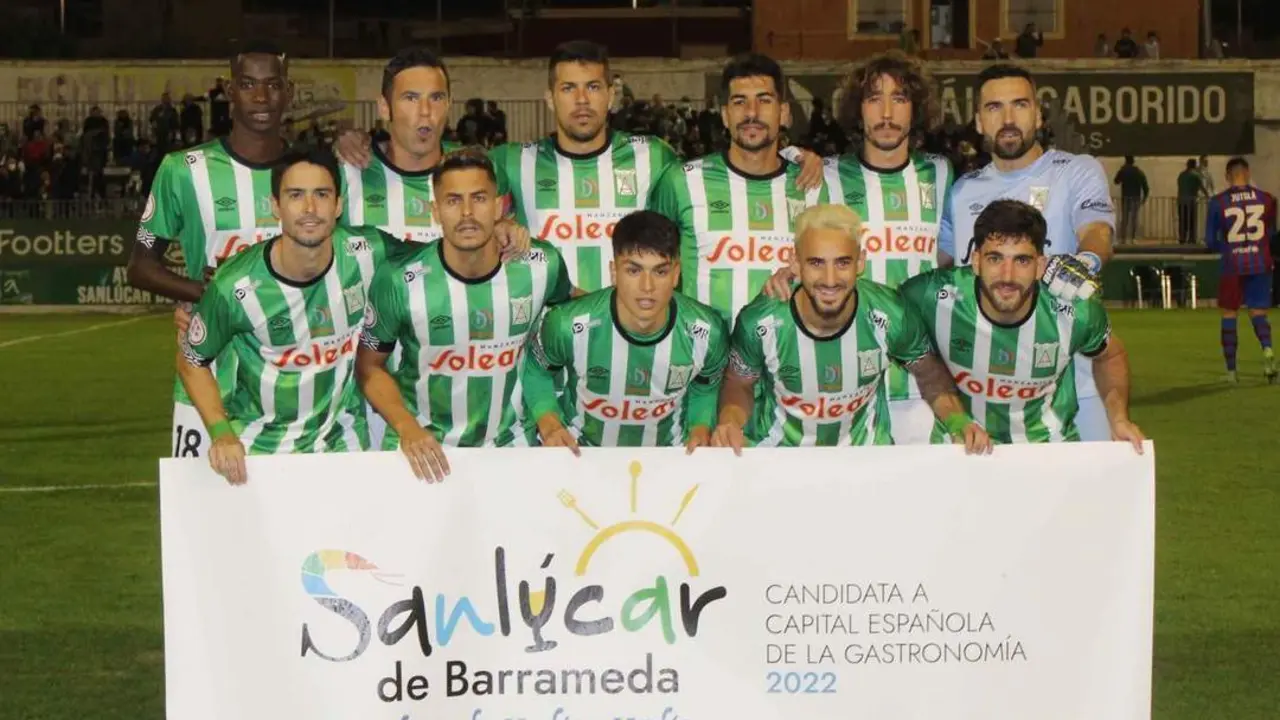 Los jugadores del Atl&eacute;tico Sanluque&ntilde;o con la pancarta antes de enfrentarse al Barcelona B - Ra&uacute;l J. Bustillos