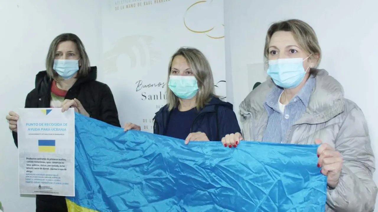 Olha Charnosh, Halina Lavryk y Svitlana Savchuk con la bandera de Ucrania y el cartel de apoyo - Ra&uacute;l J. Bustillos
