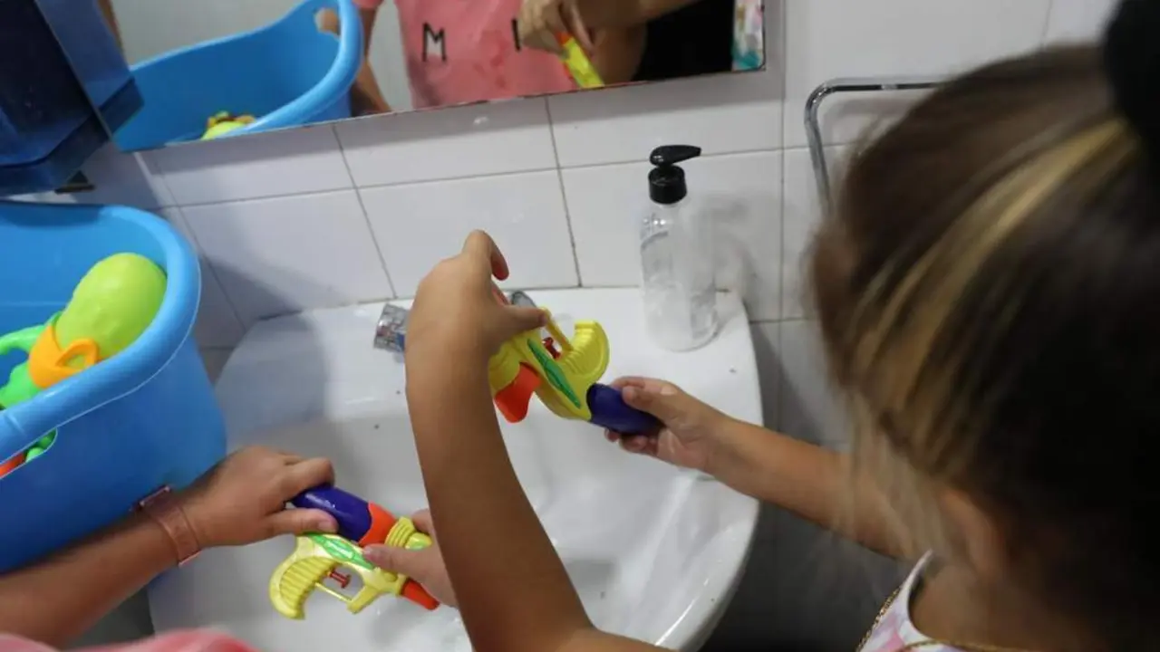 Una ni&ntilde;a recarga una pistola de agua. - Europa press