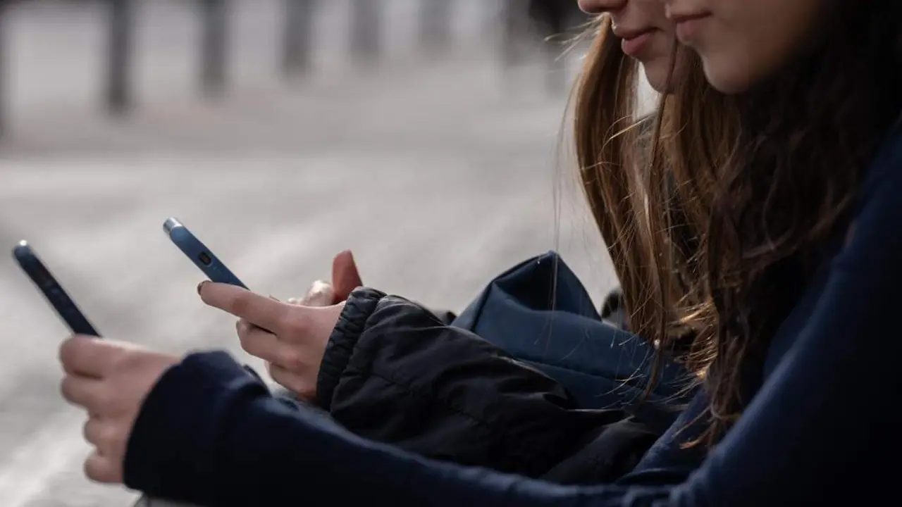 Dos personas usan el tel&eacute;fono m&oacute;vil. - Europa Press
