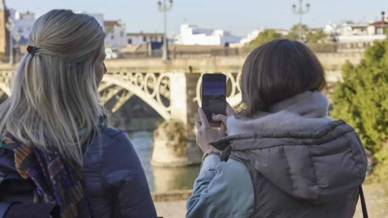 Dos turistas fotograf&iacute;an el puente de Triana. - Europa Press