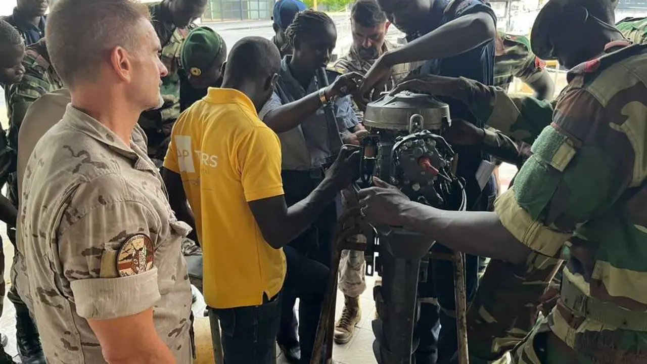 Los marinos senegaleses con un motor fueraborda. | EMAD.
